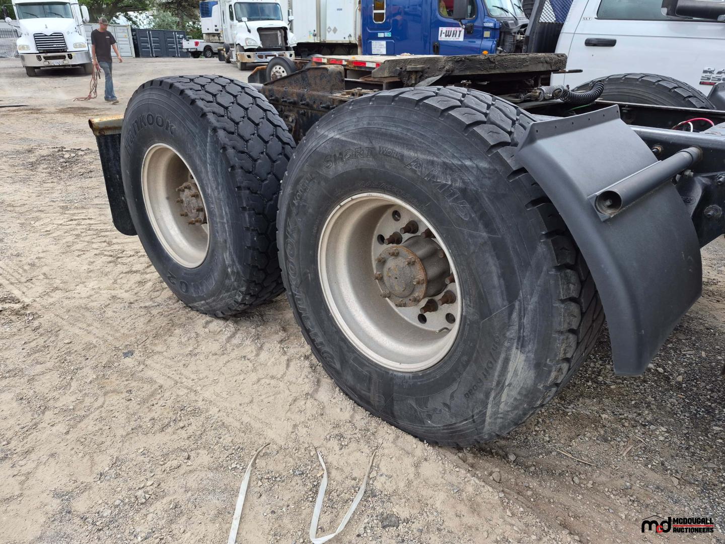 Freightliner Cascadia rear axle with dual tires and chassis in view showing tire treads and wheel rims.