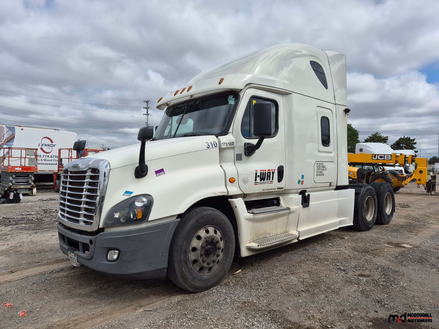 Freightliner Cascadia tandem tractor cab in view showing front grille, headlights, and side mirrors; white exterior with sleeper cab and rear coupling visible.