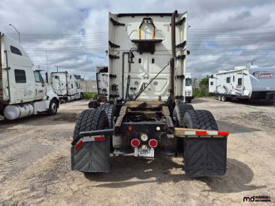 Freightliner Cascadia rear view showing fifth-wheel area, dual rear axles, and mud flaps.