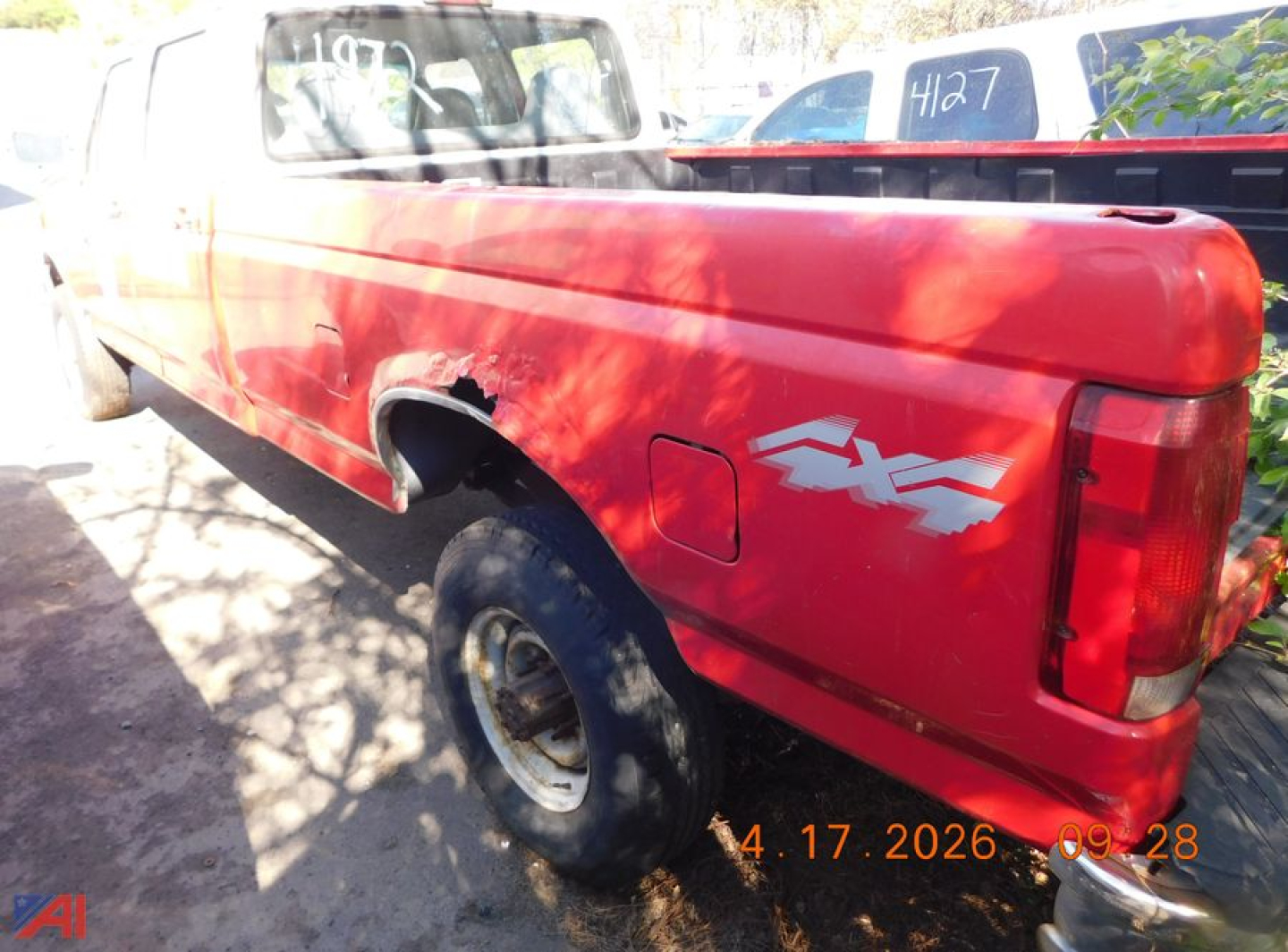 Ford F-350 pickup truck side/back view showing red cab and bed with FX4 decal and rear quarter panel