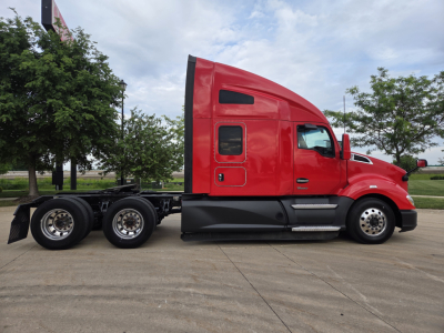 Kenworth T680 tractor unit in red, side profile view showing sleeper cab and dual rear axles.