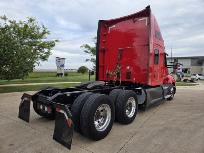 Kenworth T680 truck side and rear view showing red sleeper cab, dual rear axles, chrome wheels, and rear mud flaps.