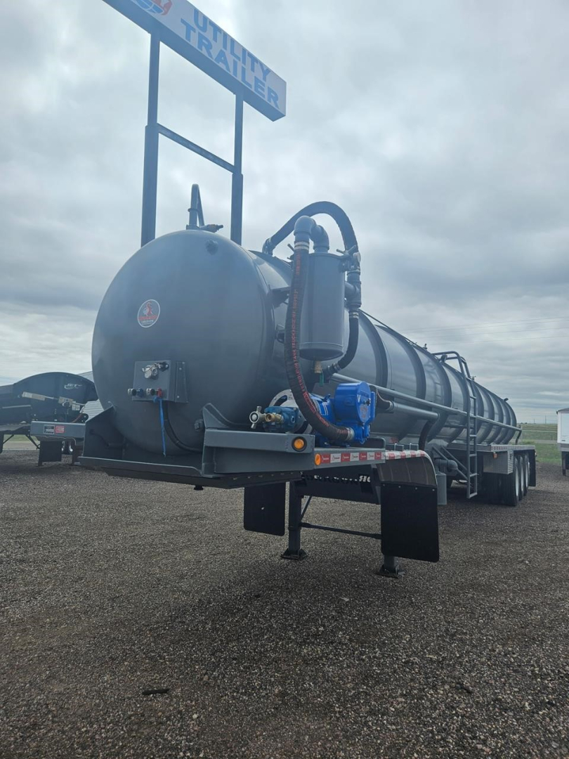 Dragon Quad Axle Non Code Vac Tank trailer showing cylindrical tank with hoses and control panel on rear, mounted on dual-axle trailer.