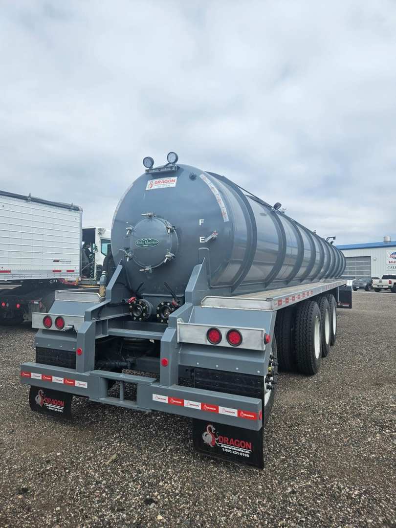 Dragon Quad Axle Non Code Vac Tank trailer rear view showing large cylindrical tank, rear lights, mud flaps with Dragon logo, and safety rails.