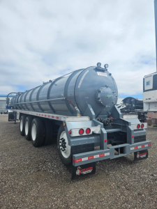 Dragon Quad Axle Vac Tank trailer rear view showing cylindrical tank and triple-axle setup with rear lights and mud flaps.
