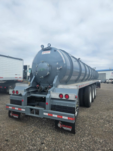 Dragon Quad Axle Non Code Vac Tank trailer rear view showing large cylindrical tank, rear lights, mud flaps with Dragon logo, and safety rails.