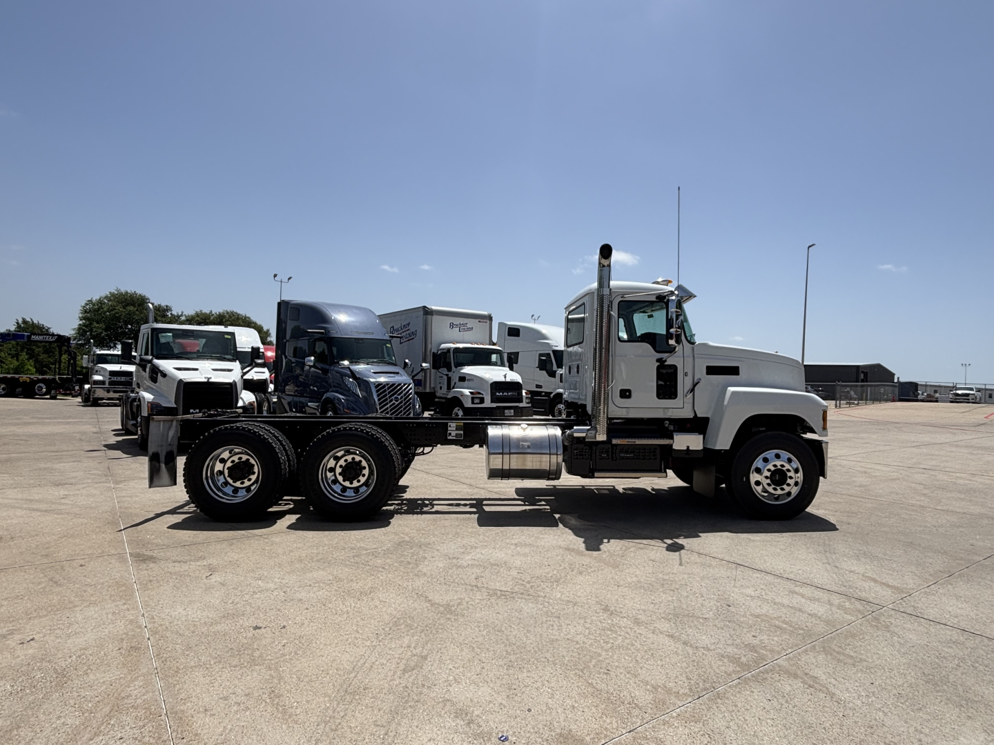 2027 Mack PI64 dump truck side view showing chassis and rear axles with dual rear wheels.