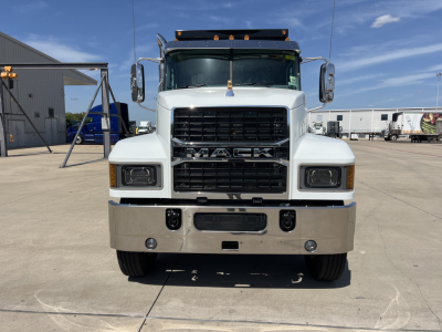 Mack PI64 front view showing grille with MACK emblem, large bumper, headlights, and chrome mirrors.