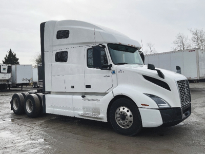 Volvo VNL 760 tractor in white, side view showing sleeper cab, dual rear axles, and front grille; no visible text on components.