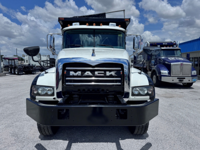Grille of 2023 Mack GR84F dump truck with prominent Mack logo and front bumper.