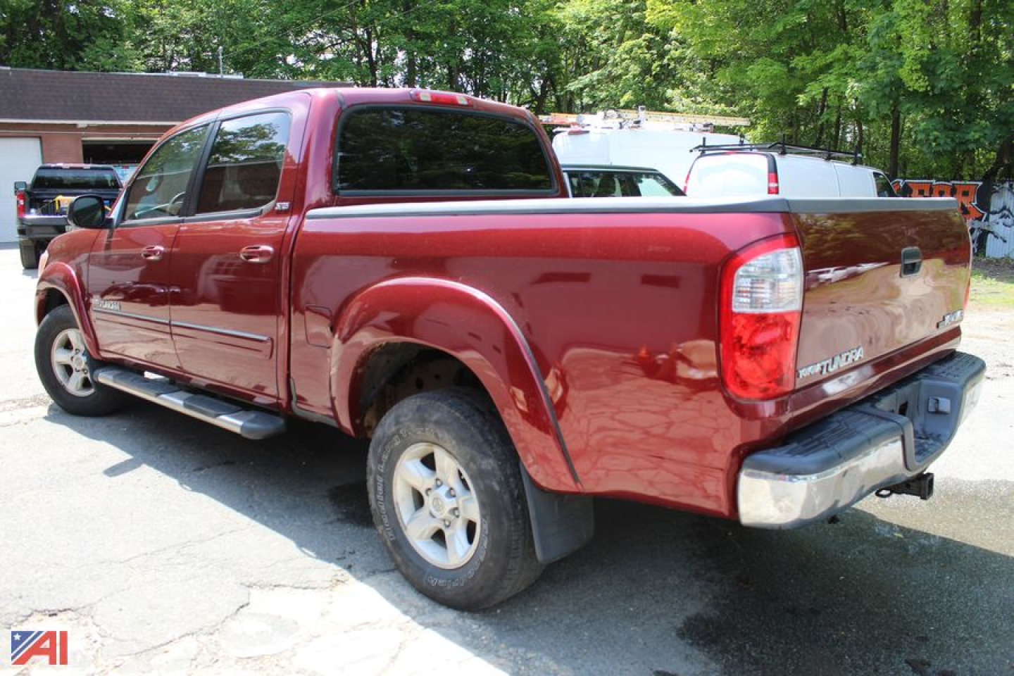 Toyota Tundra crew cab pickup truck with red exterior, rear view showing cargo bed and tailgate