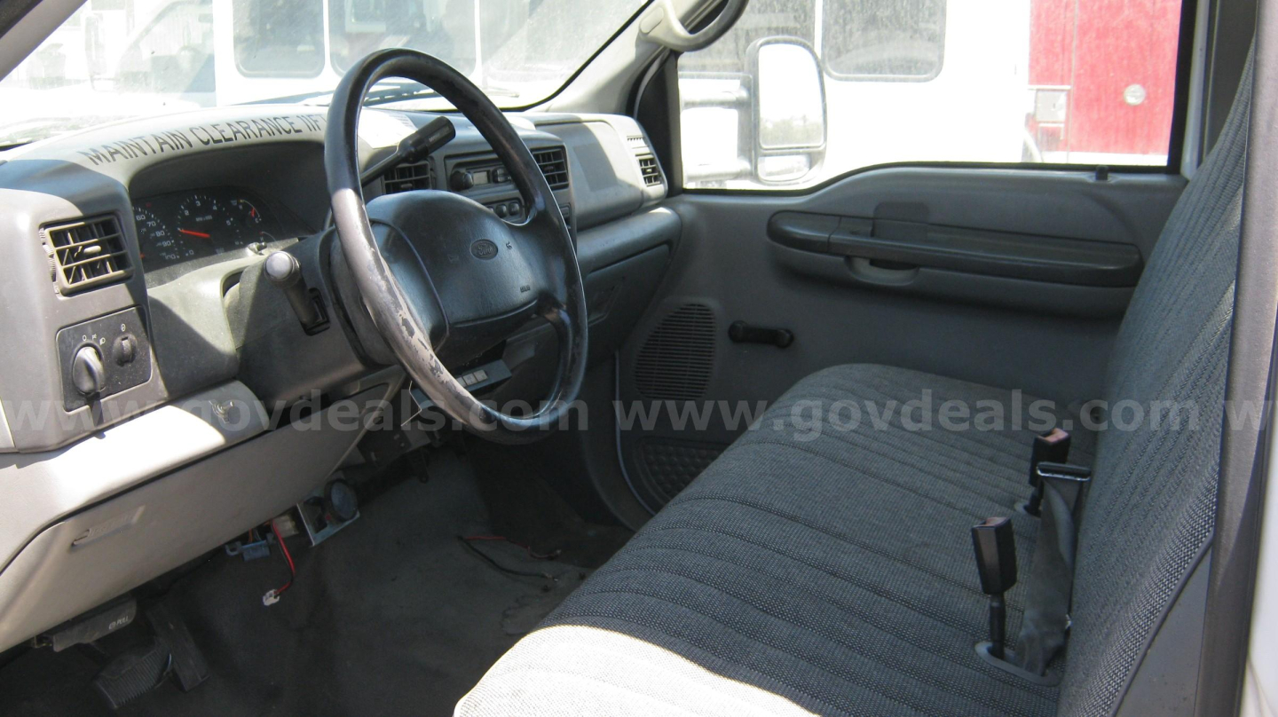 2002 Ford F-550 interior showing steering wheel, dashboard, and front bench seat. Visible text: none clearly legible.