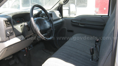 2002 Ford F-550 interior showing steering wheel, dashboard, and front bench seat. Visible text: none clearly legible.