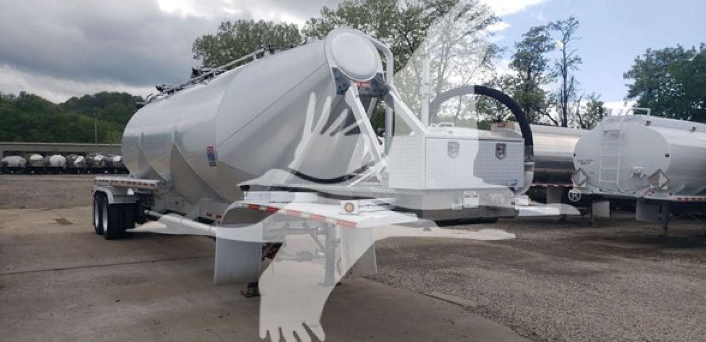 Pneumatic dry bulk trailer showing cylindrical tank on dual-axle chassis with front toolbox and hitch.