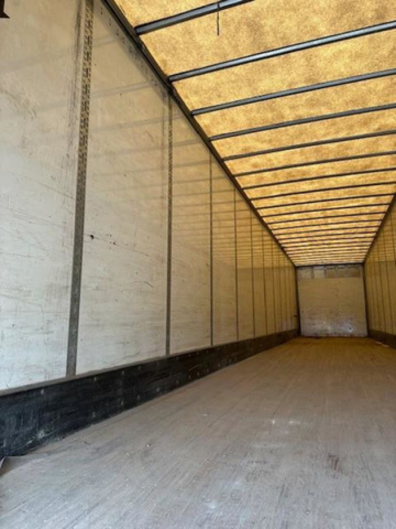 Interior trailer photo showing empty cargo area of a 2014 Wabash van trailer, long rectangular box with wooden floor and metal side walls.