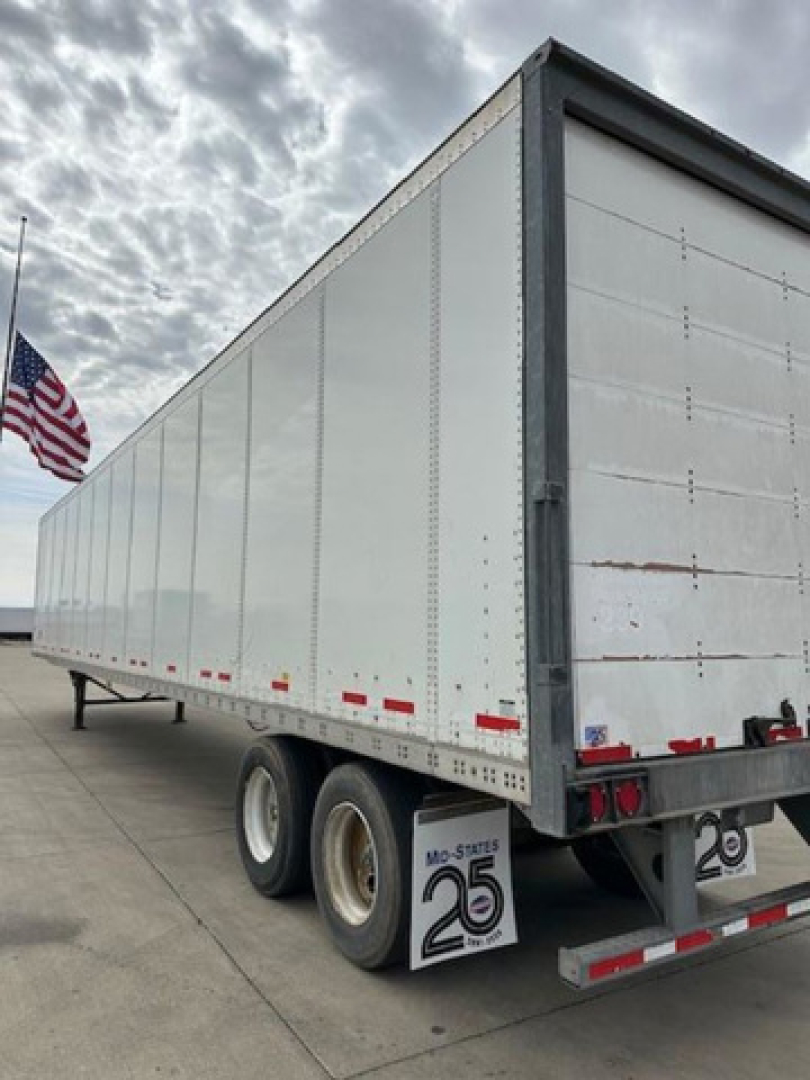 Trailer side view showing a 2014 Wabash van trailer with tandem axles and loading doors, stock U90796, VIN 1JJV532D4EL786701.