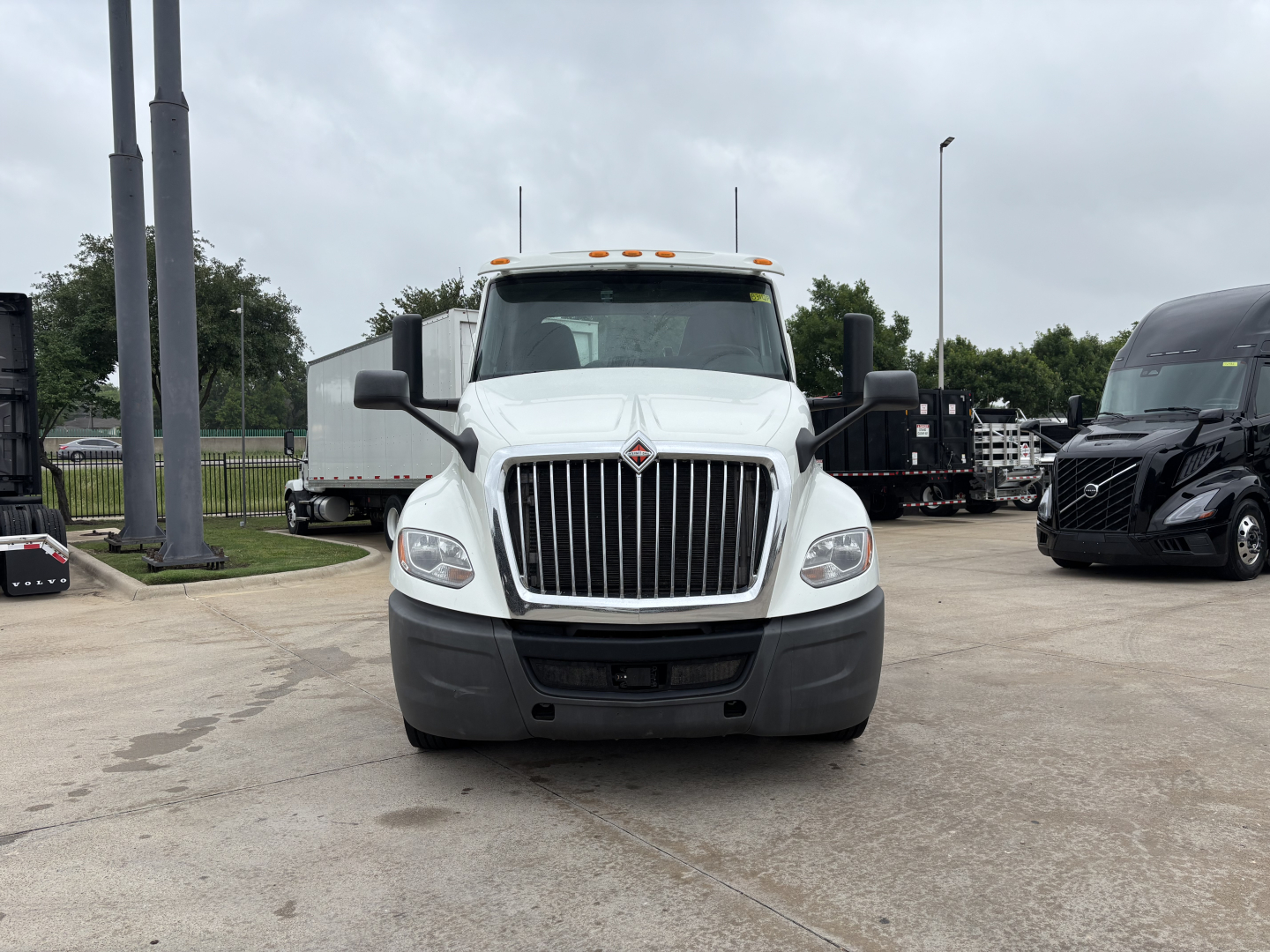 Front view of a white 2019 International LT conventional daycab truck with large grille and bumper, daytime running lights, and side mirrors visible.