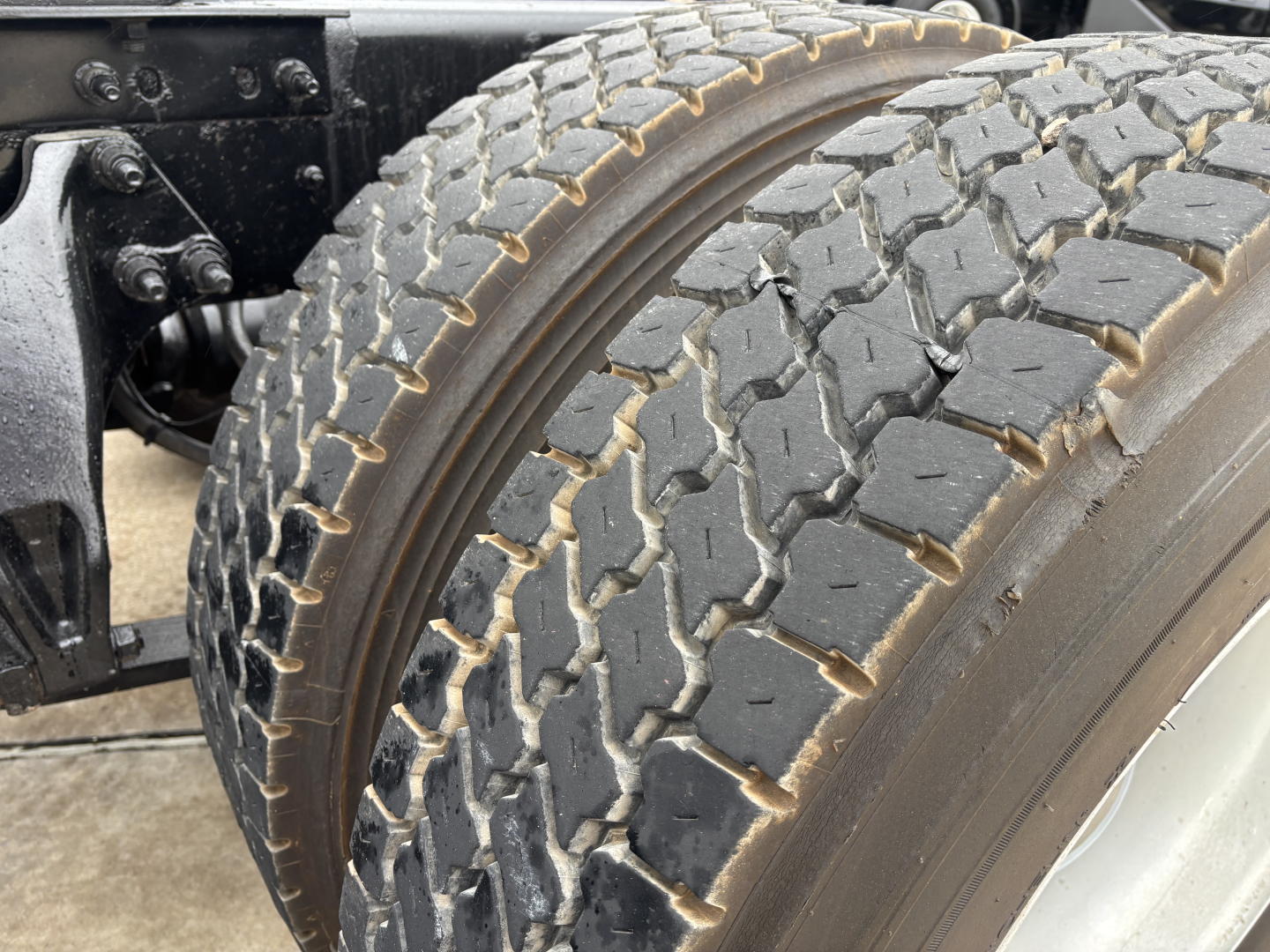 Truck rear dual tires on International LT cab chassis showing tread and sidewall details.