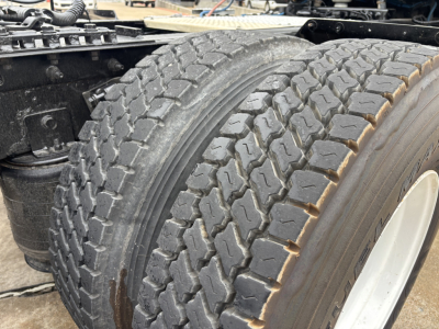 Truck axle and dual tires showing tread pattern in the primary image.