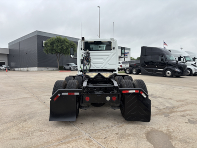 Rear view of a 2019 International LT conventional daycab truck chassis with dual rear axles in a dealership lot.