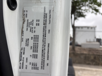 Plate on vehicle door showing specifications for a 2019 International LT conventional daycab truck including VIN 3HSDZTZR6KN135642, stock B3112P, and various weights and safety ratings.