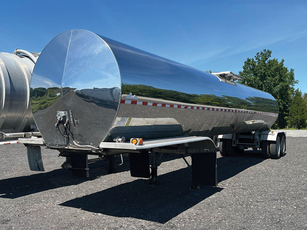 Polar stainless steel tank trailer showing cylindrical polished tanker with reflective surface and rear wheels.