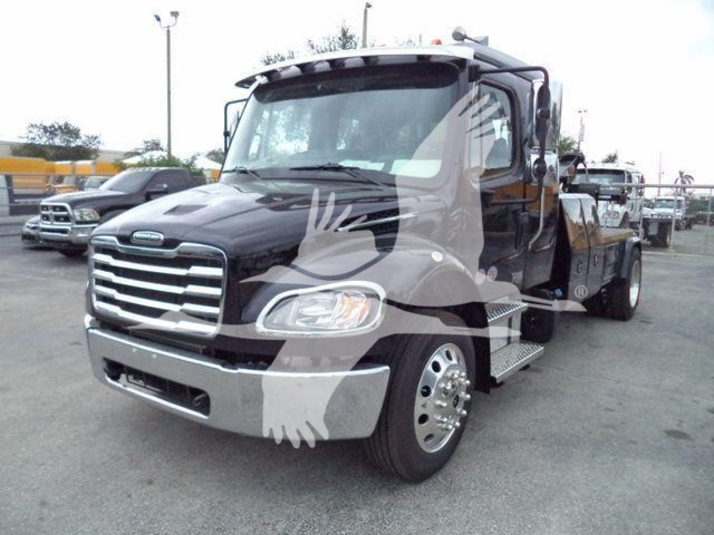 Freightliner M2 106 cab with winch chassis and front grille view.