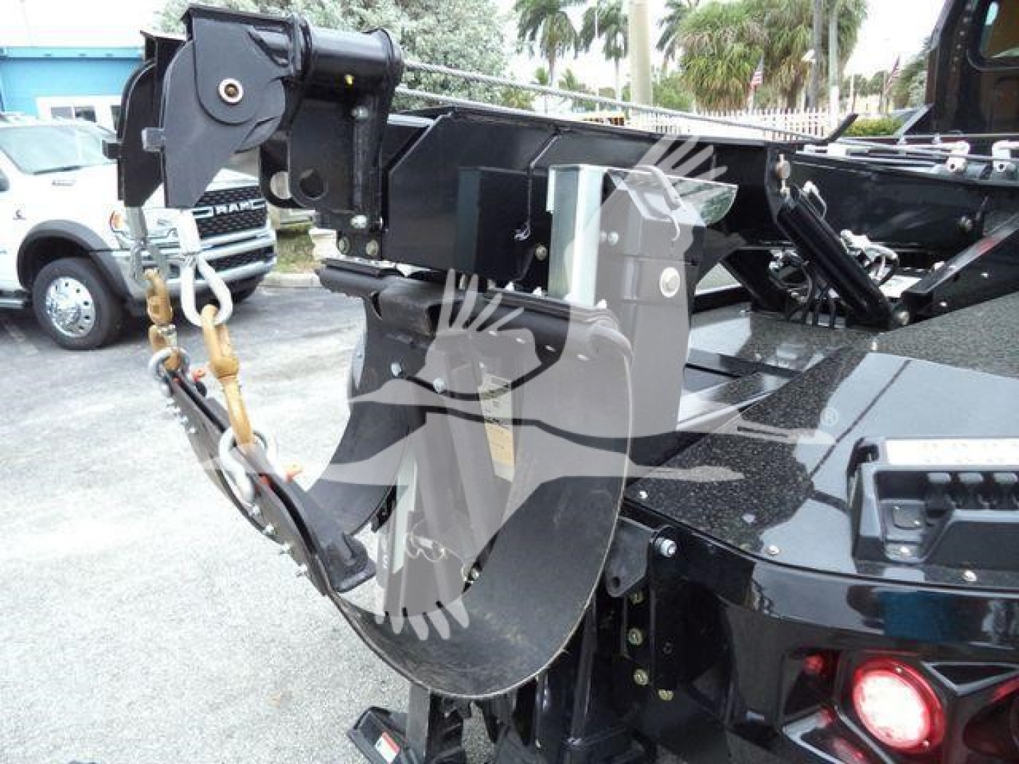 Freightliner M2 106 winch setup showing hook block and hydraulic winch assembly with black metal frame and hydraulic lines.