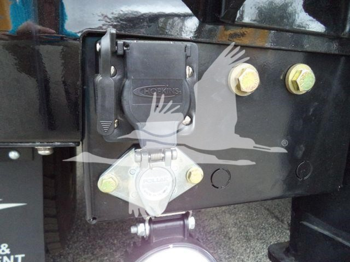 Freightliner M2 106 winch setup showing Hopkins electrical/connector block mounted on black chassis with bolts and reinforced bracket