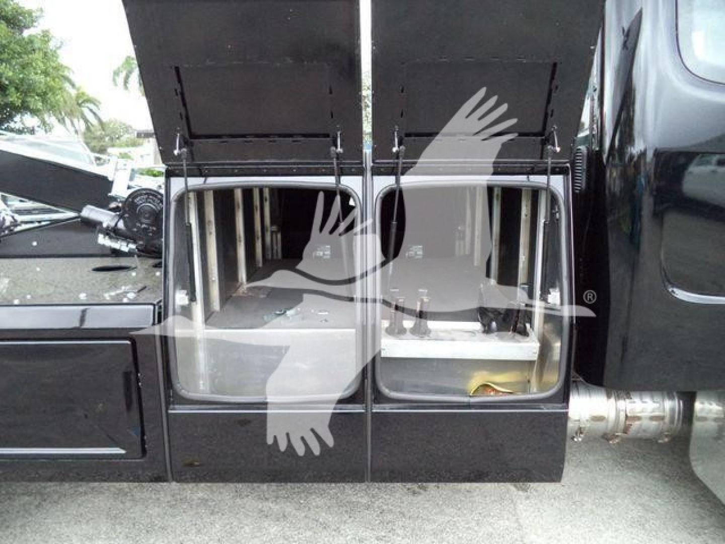 Freightliner M2 106 side view showing external winch storage compartments with lid open.
