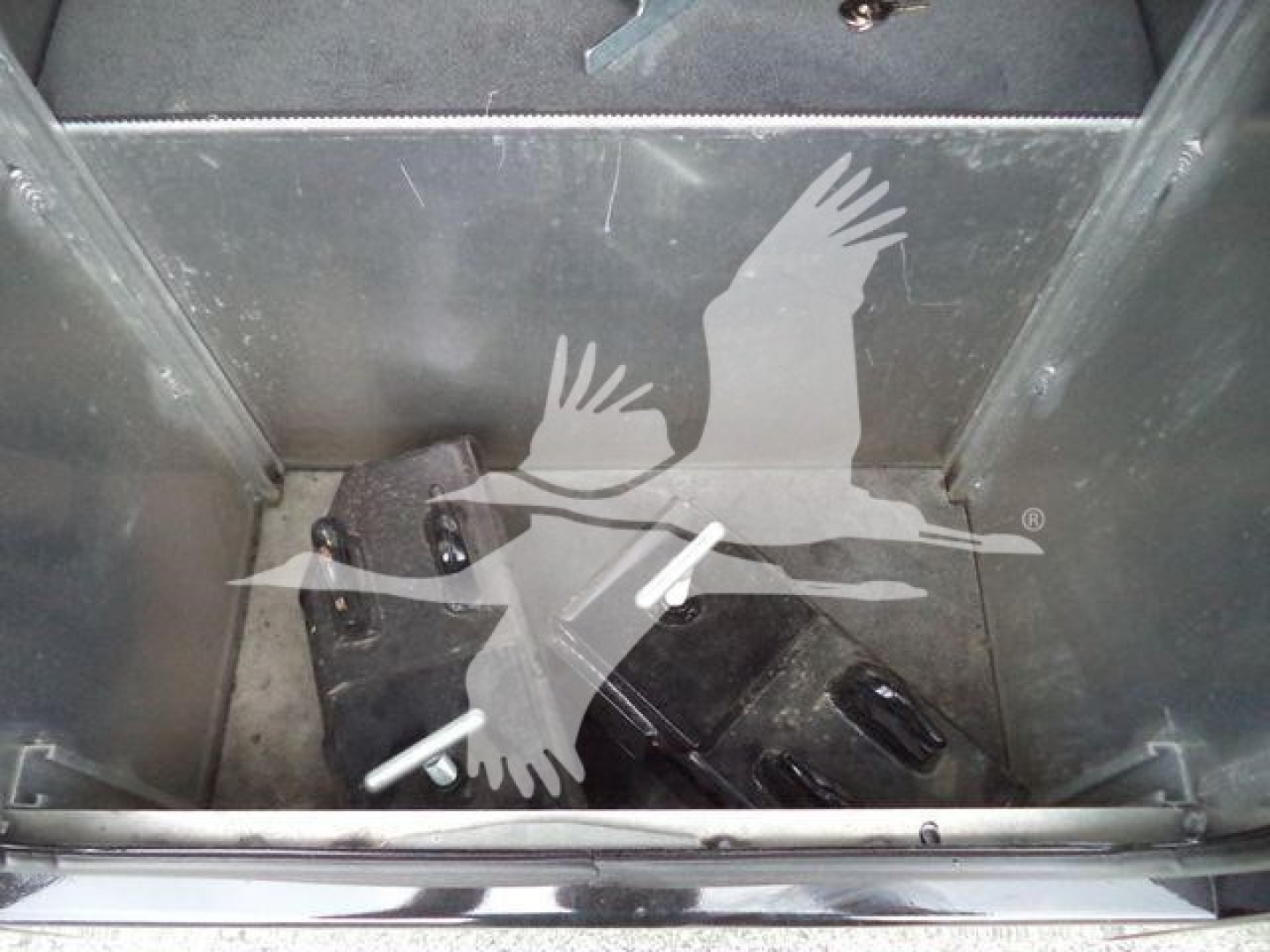 Freightliner M2 106 winch truck interior showing metal storage bin and mechanical components with some white spray paint marks.