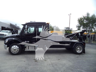 Freightliner M2 106 truck with winch-equipped bed, side view showing cab, chassis, and wheels.