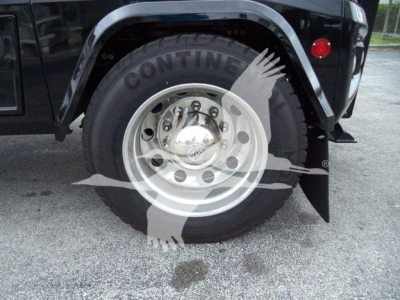 Wheel and front fender of a Freightliner M2 106 truck showing Conti tire and shiny chrome wheel with hubcap.