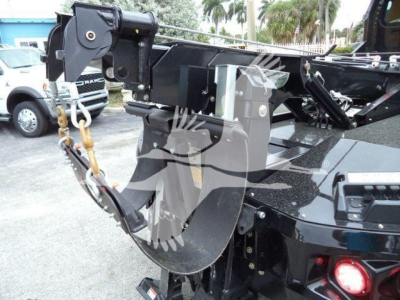 Freightliner M2 106 winch setup showing hook block and hydraulic winch assembly with black metal frame and hydraulic lines.