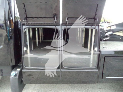 Truck cab interior view showing open compartments and winch equipment on Freightliner M2 106, stock JU6169FM.