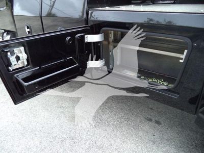 Freightliner M2 106 truck bed area showing side storage and winch compartment with open access door.