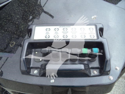 Winch control panel on Freightliner M2 106 showing multiple labeled levers and colored safety caps.