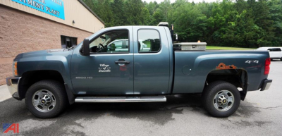 2013 Chevrolet Silverado 2500HD Extended Cab with Plow showing side profile in blue with four doors and utility bed, plow mount, and Silverado badge.