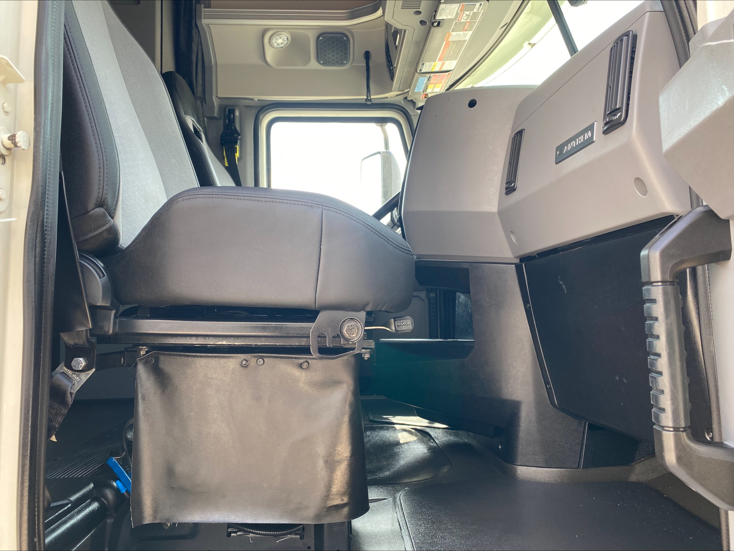 Cab interior of a 2020 Mack Anthem truck with driver seat and dashboard visible