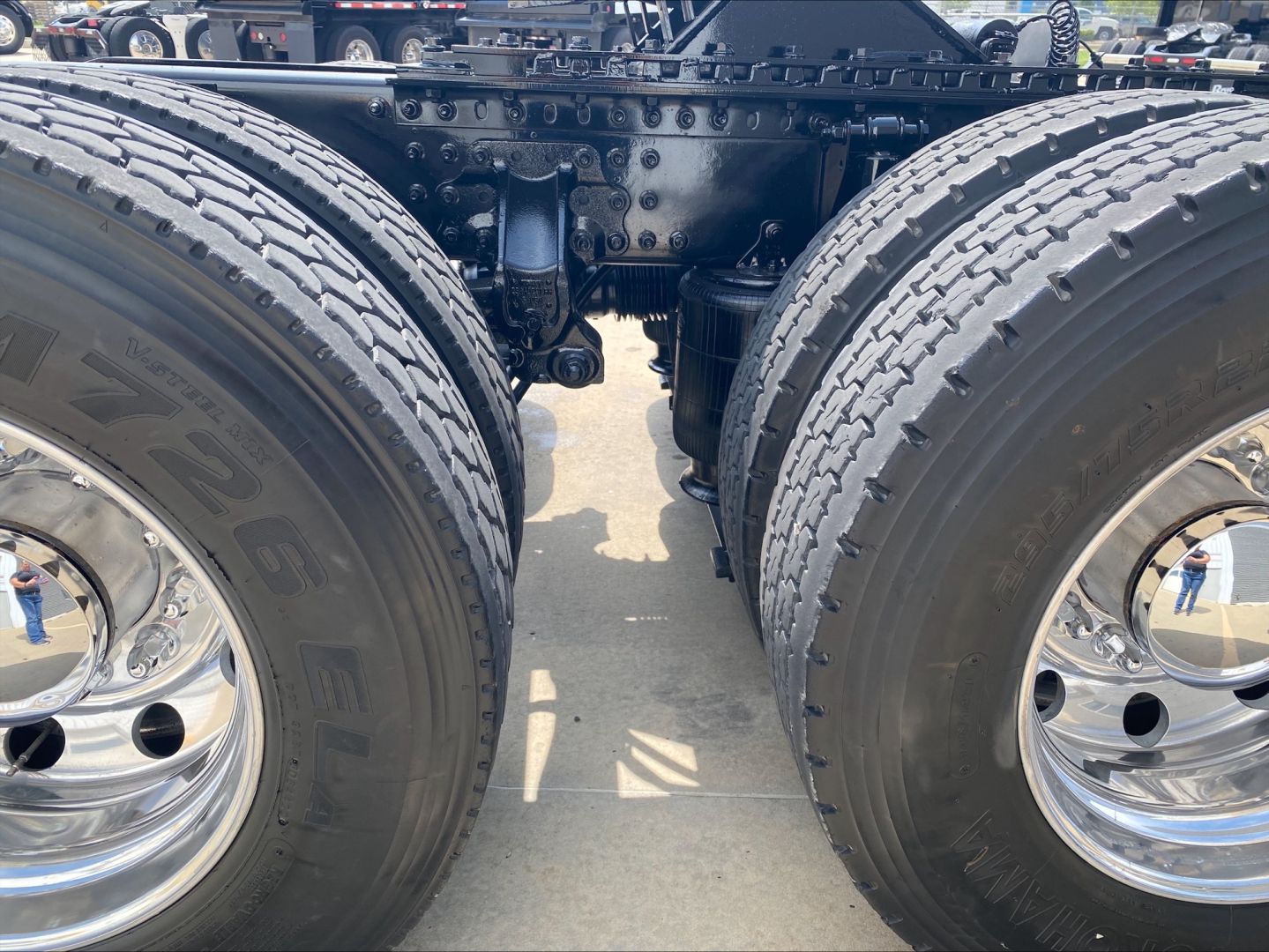 Twin rear axles of a 2020 Mack Anthem truck show dual tires and chrome wheels; chassis and suspension components visible between the wheels.