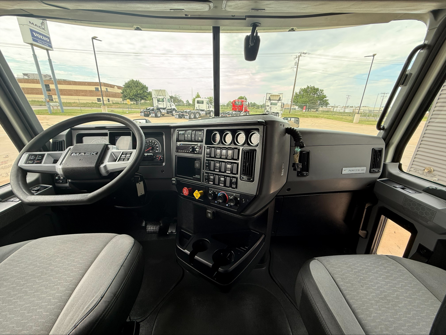 Cockpit view of a 2020 Mack ANTHEM truck interior showing dashboard controls, steering wheel, and two front seats.