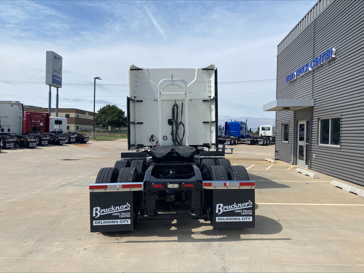 Rear view of a 2020 Mack Anthem tractor-trailer in a dealership yard, showing rear bumper, mudflaps with Bruckners Oklahoma City, and fifth-wheel area.