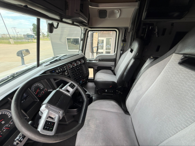 Cab interior of a 2020 Mack Anthem truck showing steering wheel, dashboard with gauges, and front seats.
