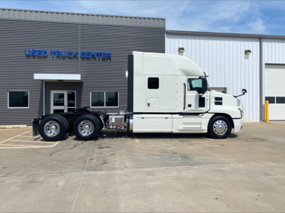 Truck side view of a white 2020 Mack Anthem sleeper cab tractor in front of a Used Truck Center building with stock number B3362P and VIN 1M1AN4GY0LM019038.