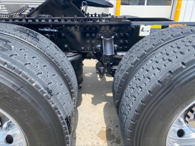 Dual rear axles of a 2020 Mack Anthem tractor showing heavy-duty suspension and drivetrain components between the wheels.