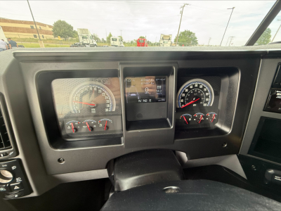 Dashboard of 2020 Mack Anthem truck showing analog gauges and center digital display