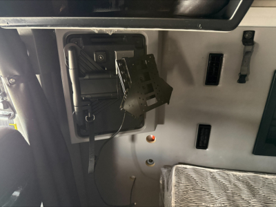 Dashboard area showing wiring harness and mounting bracket inside Mack Anthem truck cab.