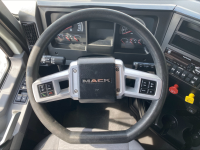 Steering wheel and dashboard of a Mack ANTHEM truck cab showing MACK emblem and control stalks.