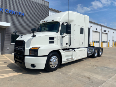 Mack ANTHEM truck tractor in white, side view showing sleeper cab and dual rear axles.
