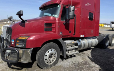 Truck: red 2020 Mack Anthem conventional sleeper tractor shown from front-left side with sleeper cab, fuel tanks, and front bumper.
